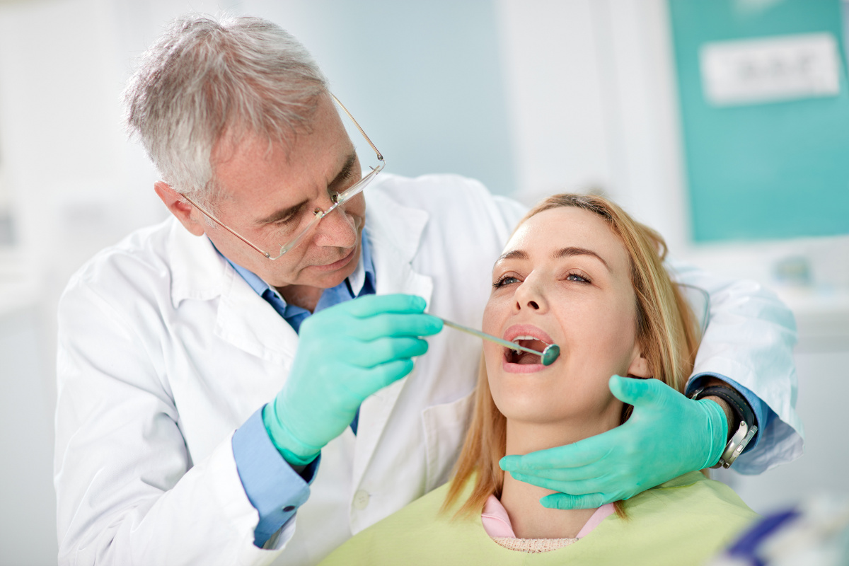 Dentist Holding Mirror for Oral Examination