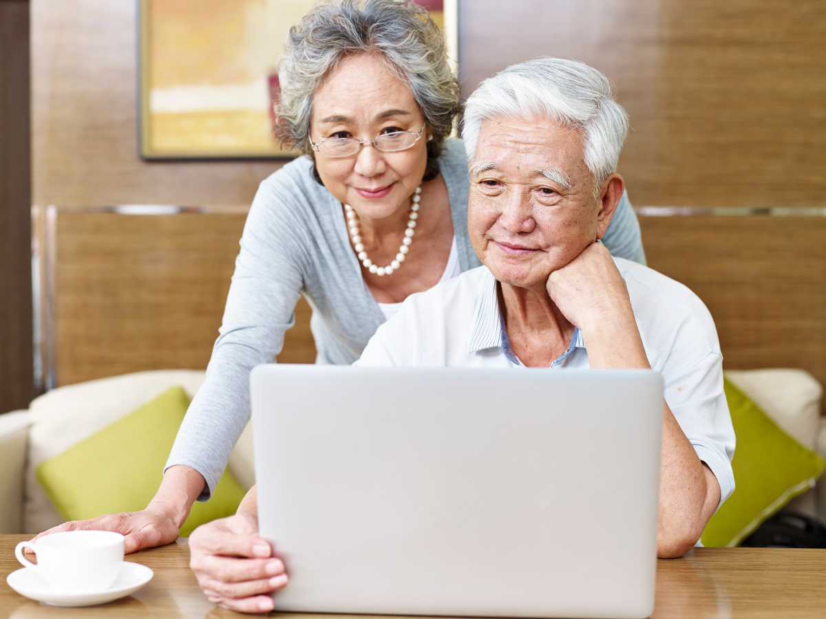 Mature Asian Couple Viewing Laptop Computer Together